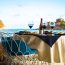 Romantic fine dining setup at Incanto Restaurant and Lounge Bar in Antigua featuring wine bottle, elegant table setting, fresh cuisine, and scenic ocean and hillside views