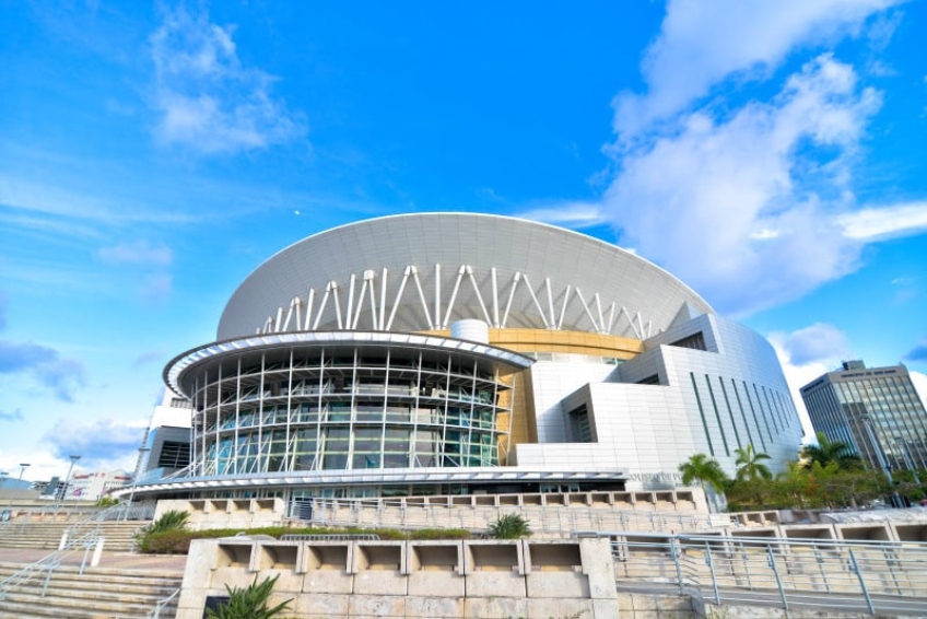 José Miguel Agrelot Coliseum in San Juan, Puerto Rico venue for 75th Diamond Anniversary Miss Universe pageant with modern dome architecture, palm trees, and blue sky